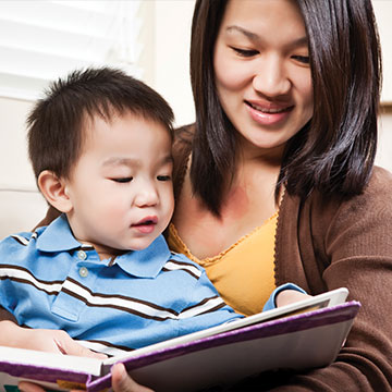 A woman reading to her son. Links to Gifts of Appreciated Securities