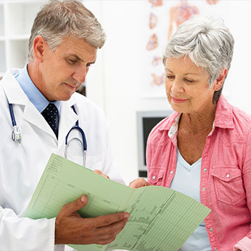 A medical professional discussing a patients test results. Links to Donor-Advised Funds