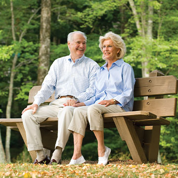 A man and his wife sitting on a bench outdoors. Links to Gifts of Cash, Checks, and Credit Cards